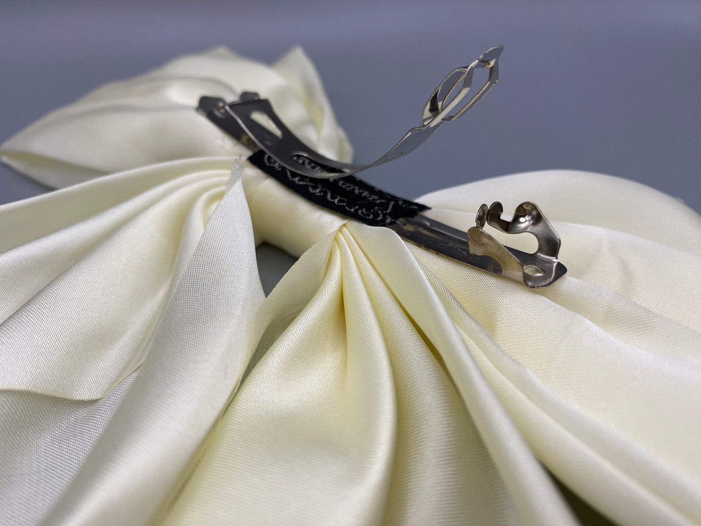 “The Amy Oversized Hair Bow in Cream, crafted from high-quality satin with an oversized bowknot design. Features a minimalist spring clamp for a secure fit. Perfect for stylish updos, daily wear, and special occasions.”