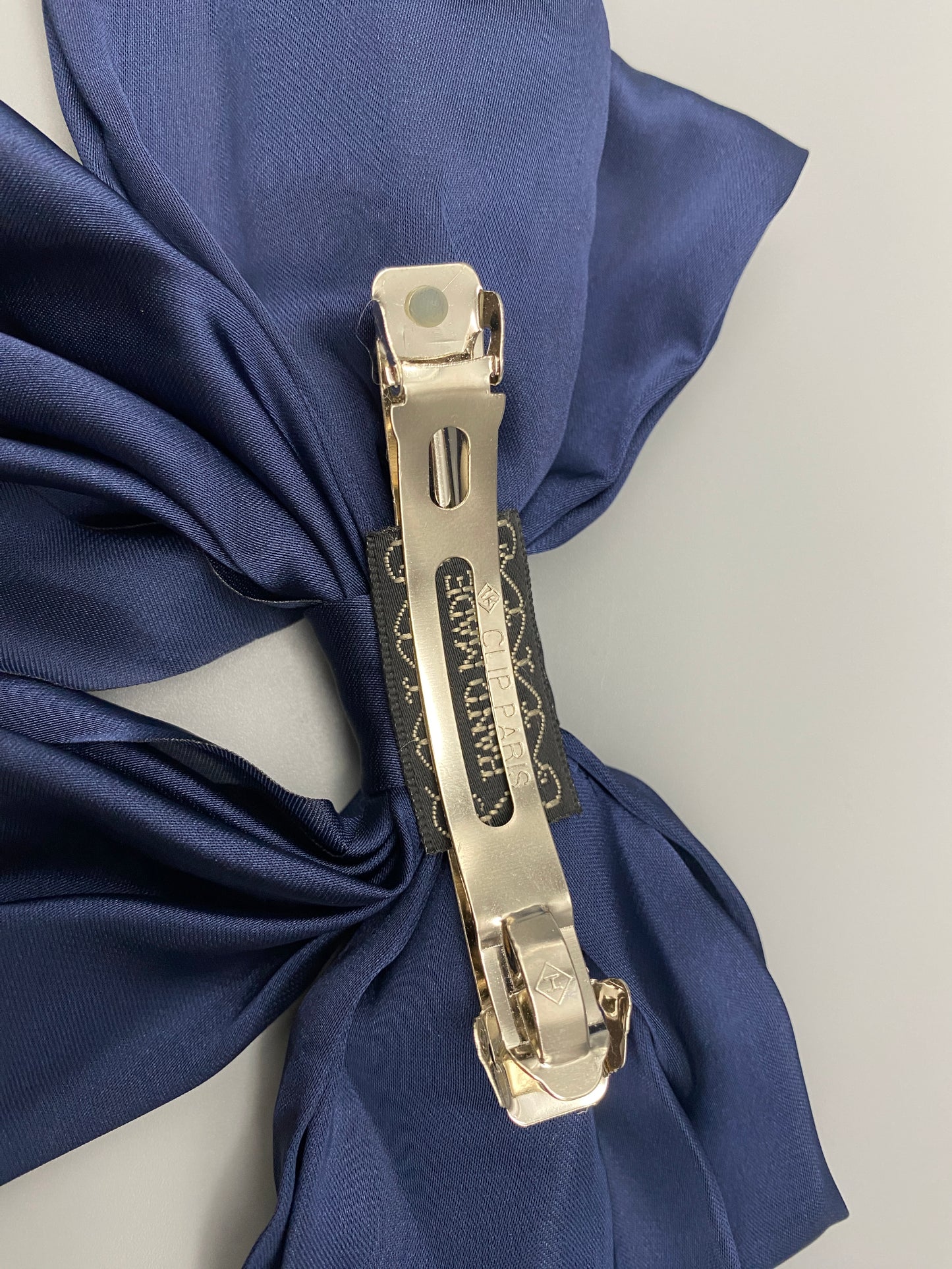 “The Amy Oversized Hair Bow in Navy Blue, crafted from high-quality satin with an oversized bowknot design. Features a minimalist spring clamp for a secure fit. Perfect for stylish updos, daily wear, and special occasions.”