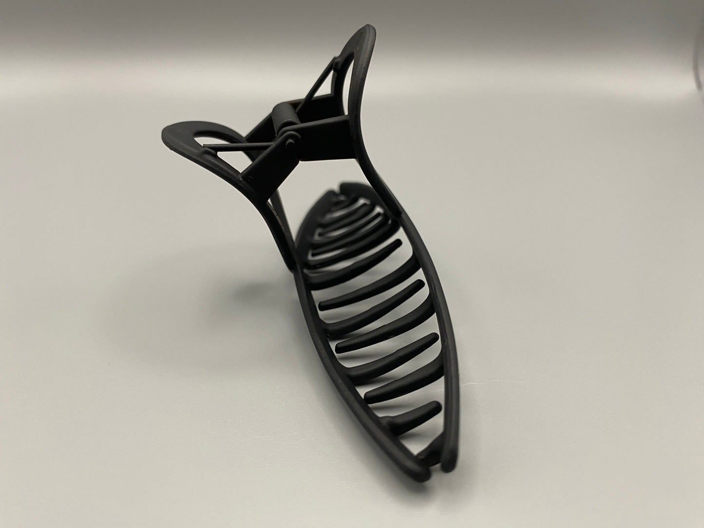 The Bethany Claw Grip Clip in Black, crafted from high-quality metal with a matte black finish. Measures 11 cm, designed for a secure hold and suitable for various hair types and styles. Durable and stylish, perfect for any outfit.”