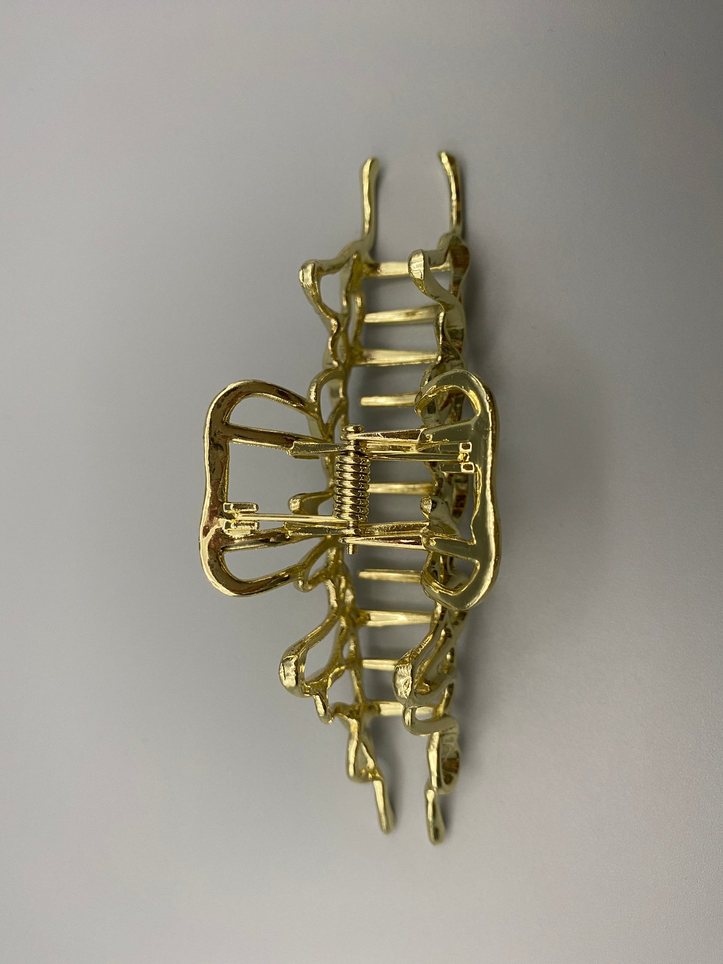 “The Luxe Claw Clip Metal Lightning in Gold, crafted from high-quality, durable metal. Measures 11 cm, featuring a luxurious gold finish and unique link design. Perfect for securing various hair types and styles, suitable for both everyday wear and special occasions.”