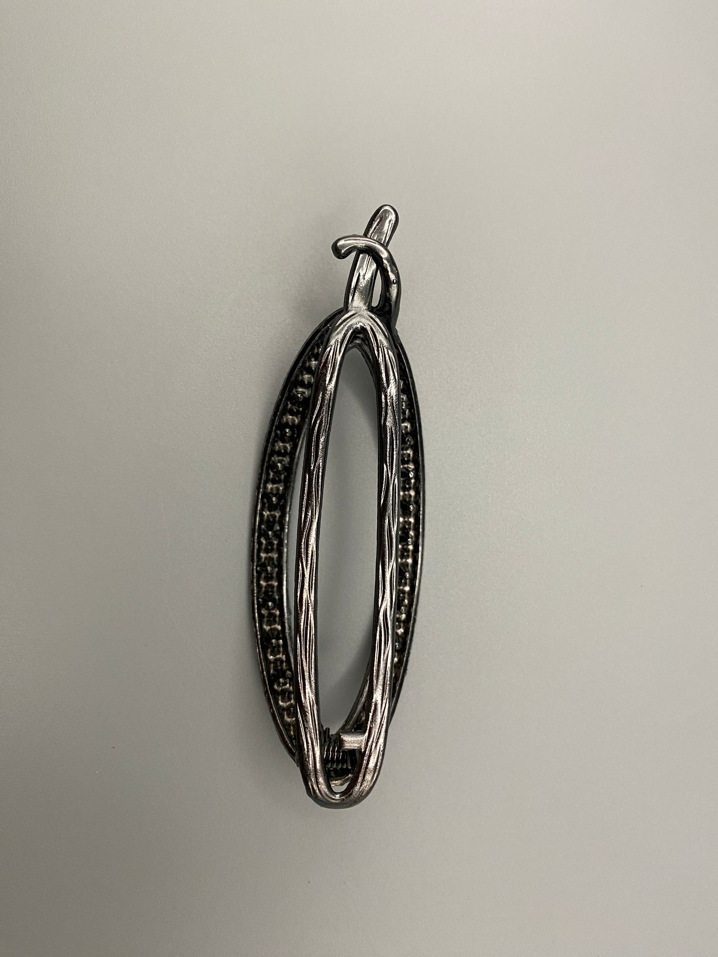 “The Missy Hair Clip, crafted from high-quality metal with sparkling zircon inlaid stones. Features a delicate curved design, measures 9 cm in length, and is perfect for securing various hair types and styl