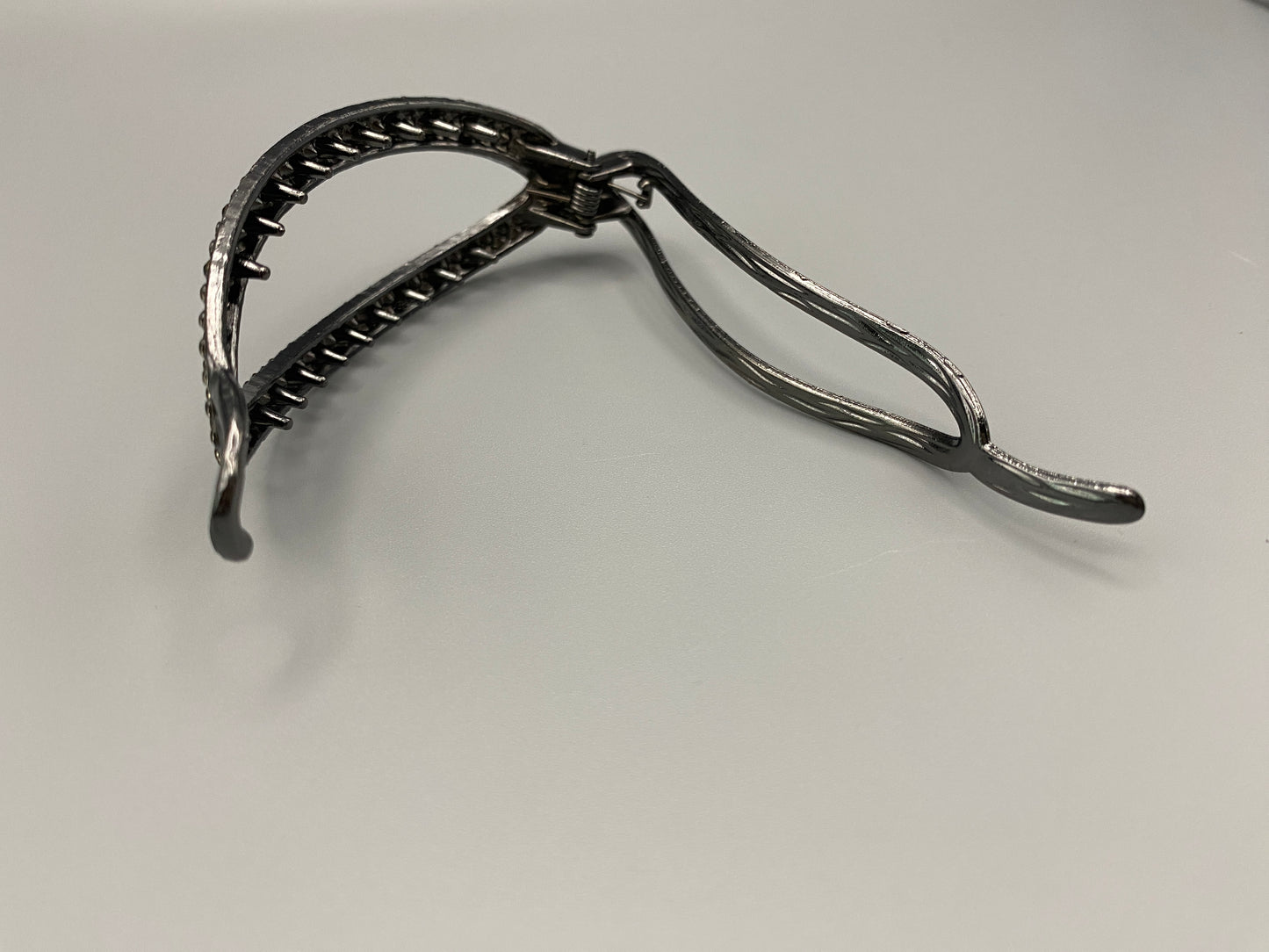 “The Missy Hair Clip, crafted from high-quality metal with sparkling zircon inlaid stones. Features a delicate curved design, measures 9 cm in length, and is perfect for securing various hair types and styl