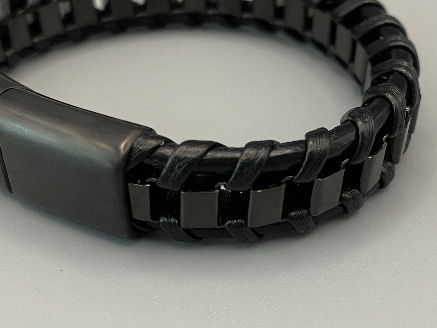 “Urban Edge Wrist Wear Men’s Bracelet in black, crafted from premium stainless steel with a casual and sporty design. Measures 19 cm in length, available in Black Zinc Plated, 18K Gold Plated, and Silver Plated finishes. Features inlay technology for added detail and craftsmanship.”