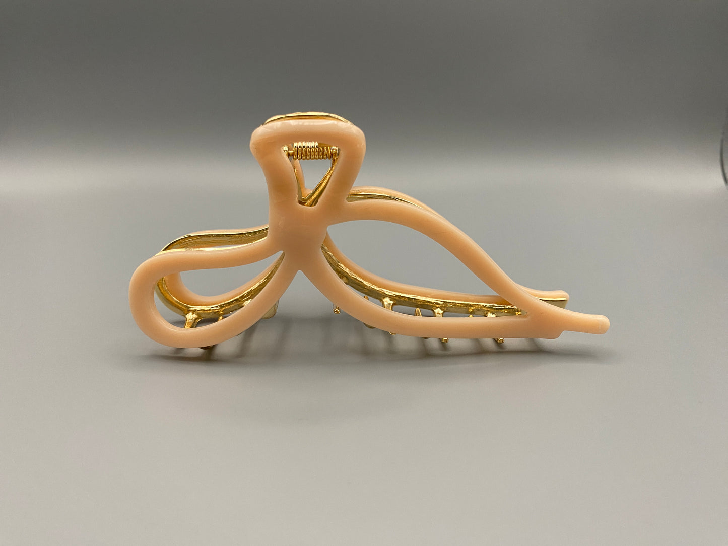  “Anastasia large metal hair claw clip in Pink and gold, perfect for securing thick hair.”