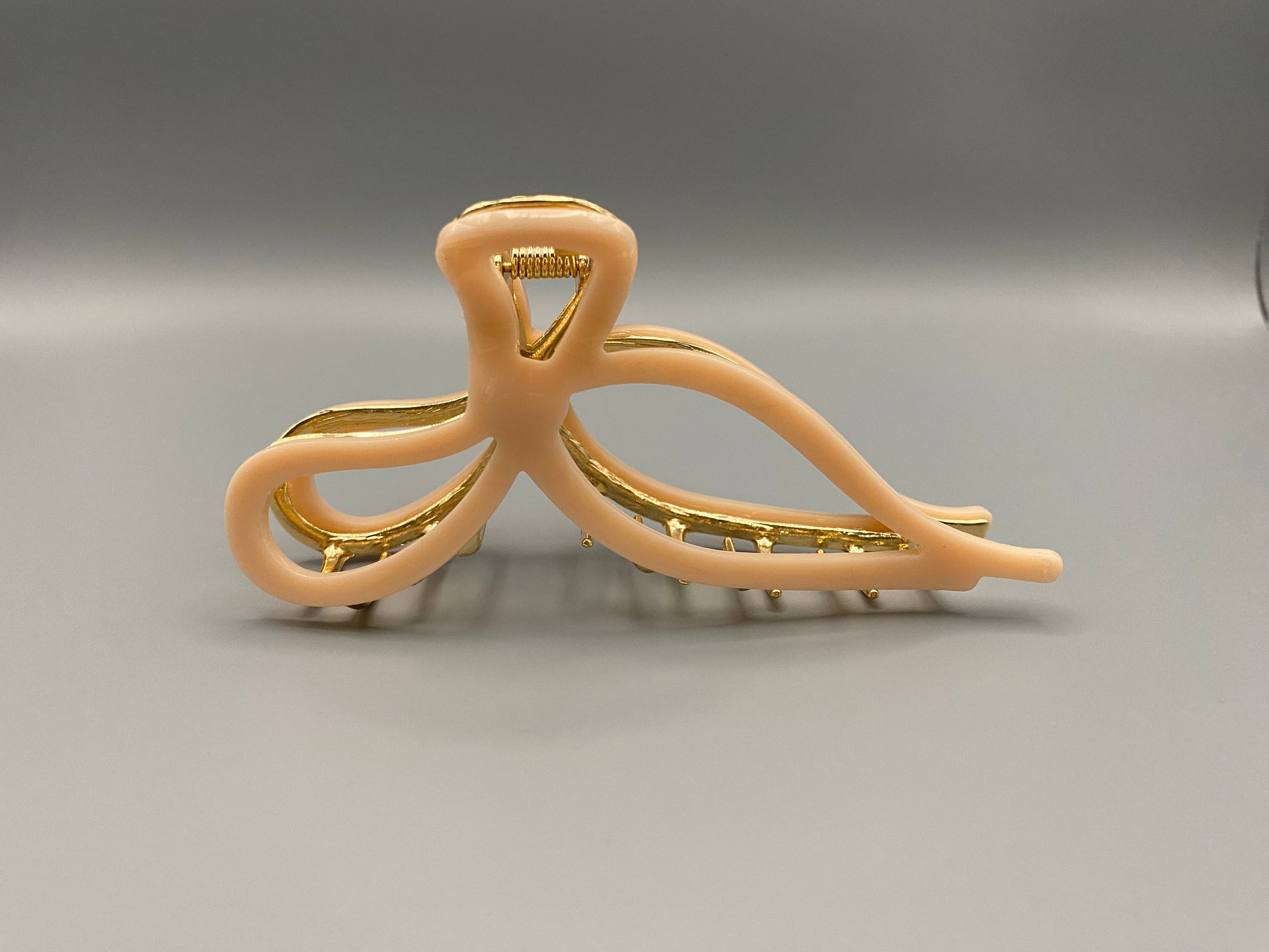  “Anastasia large metal hair claw clip in Pink and gold, perfect for securing thick hair.”