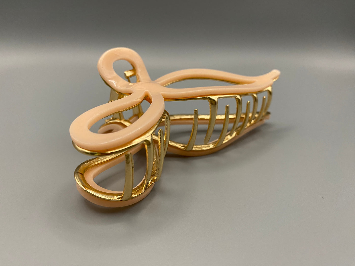  “Anastasia large metal hair claw clip in Pink and gold, perfect for securing thick hair.”