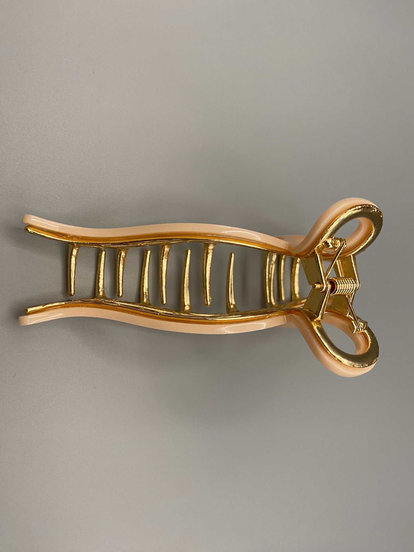 “Anastasia large metal hair claw clip in Pink and gold, perfect for securing thick hair.”
