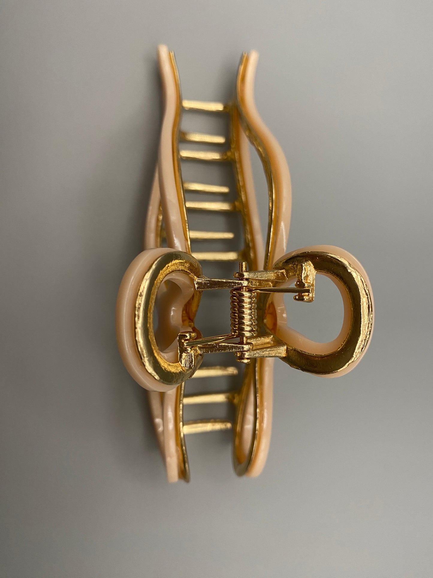  “Anastasia large metal hair claw clip in Pink and gold, perfect for securing thick hair.”