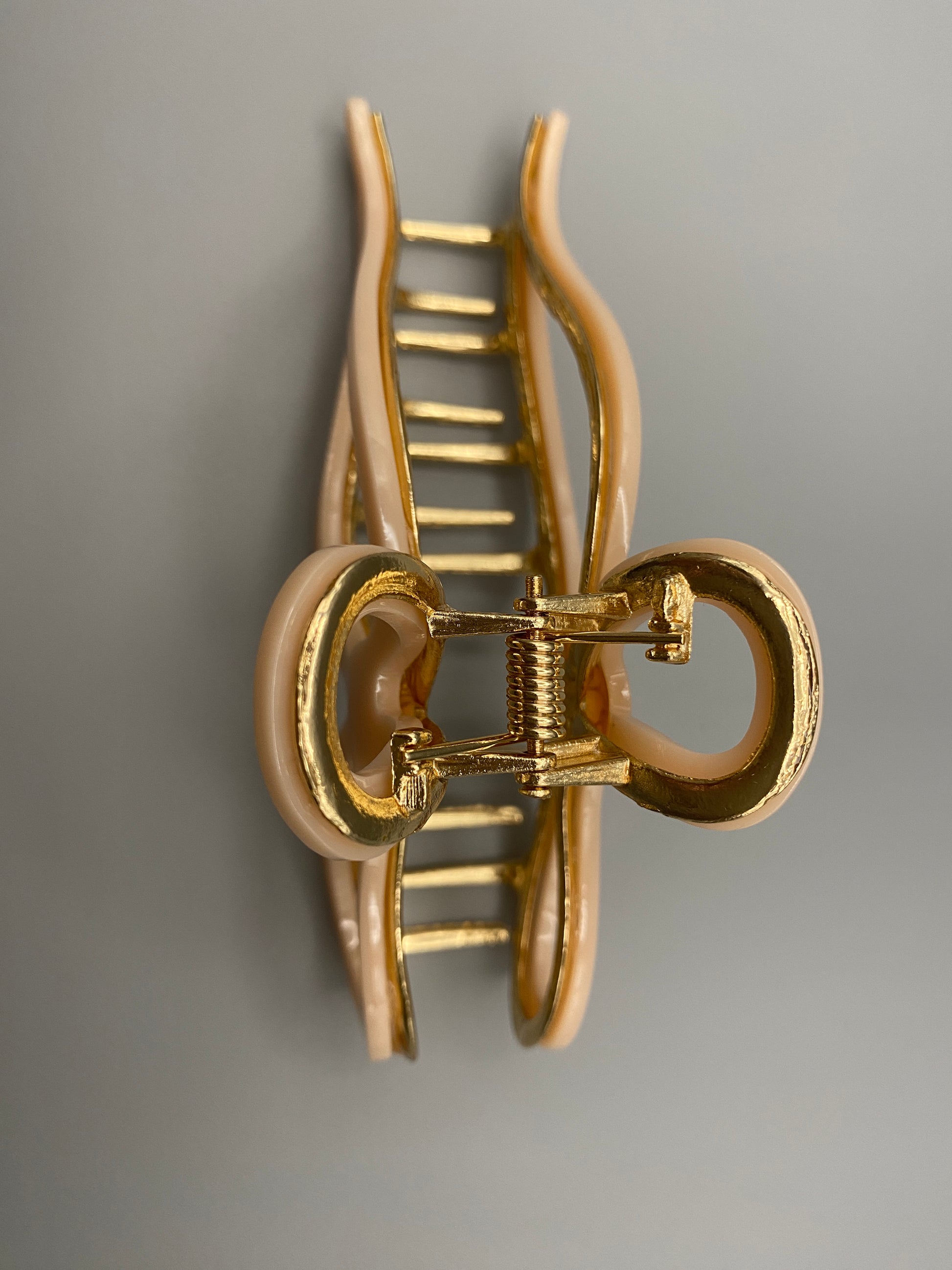  “Anastasia large metal hair claw clip in Pink and gold, perfect for securing thick hair.”