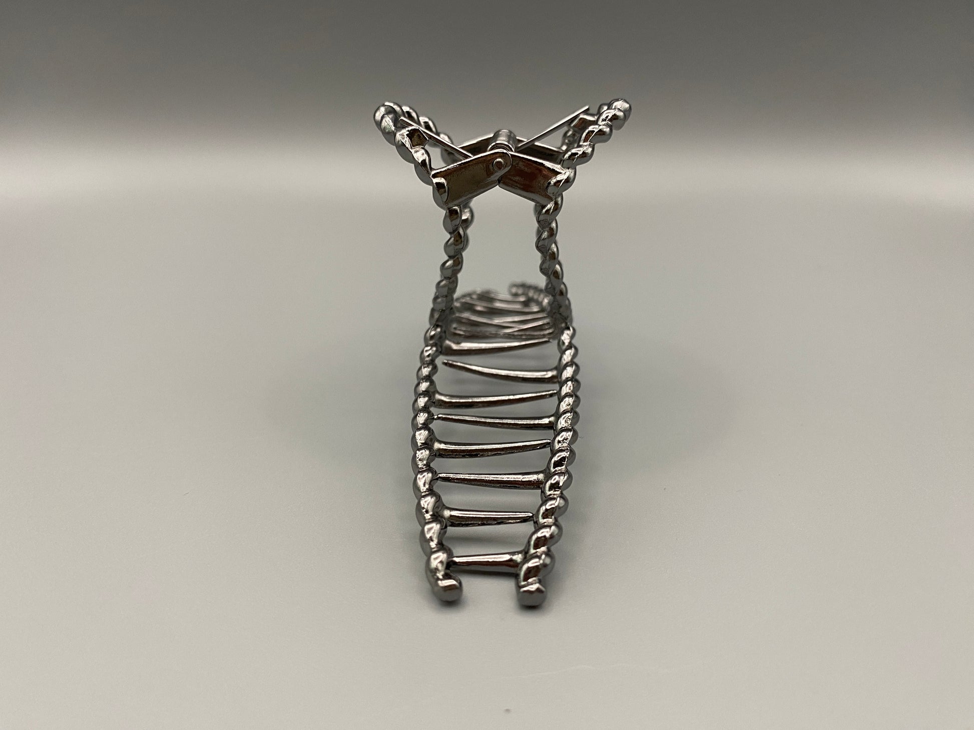 “Bellezza Claw Clip crafted from high-quality acrylic with a dark silver finish. Measures 11.5 cm in length, ideal for securing various hairstyles. Durable and stylish, perfect for both formal and casual occasions.”