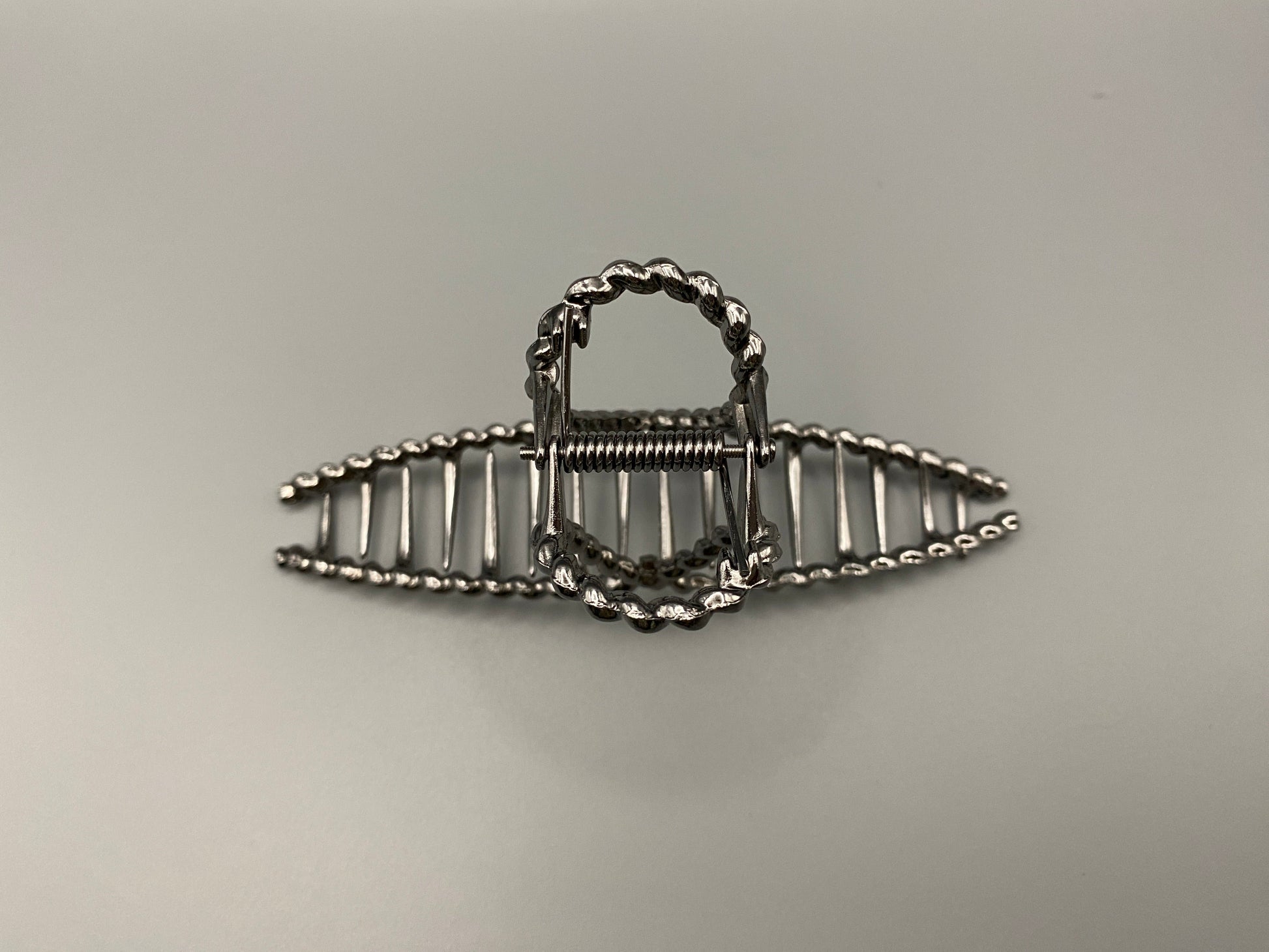 “Bellezza Claw Clip crafted from high-quality acrylic with a dark silver finish. Measures 11.5 cm in length, ideal for securing various hairstyles. Durable and stylish, perfect for both formal and casual occasions.”