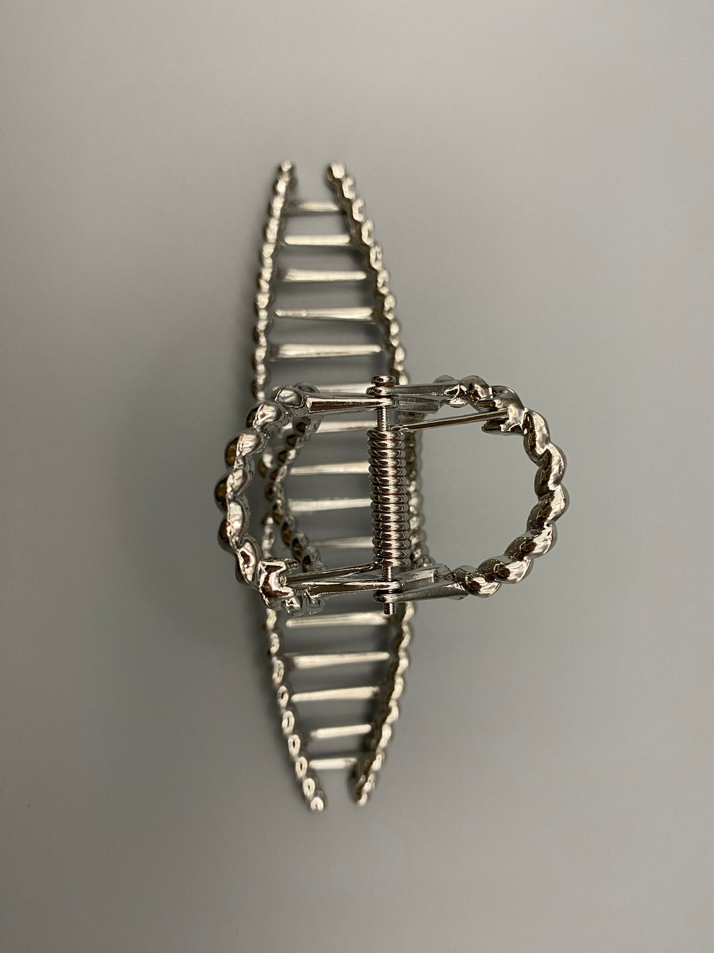 “Bellezza Claw Clip crafted from high-quality acrylic with a sleek silver finish. Measures 11.5 cm in length, ideal for securing various hairstyles. Durable and stylish, perfect for both formal and casual occasions.”