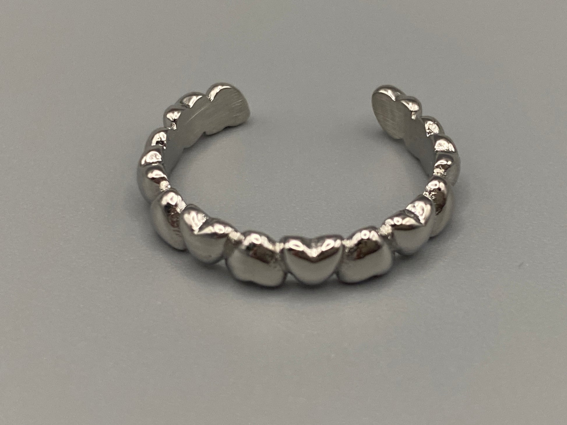 Bianca Stainless Steel Ring: Crafted from high-quality 316L stainless steel, this ring features a sleek, intertwined design that exudes sophistication. Available in size 7, it combines durability with a trendy, elegant pattern.