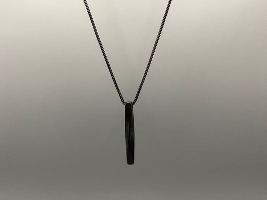 "Stainless steel twist pendant necklaces available in black gun plated, gold plated, and titanium plated finishes, displayed on a dark background. Each necklace features a geometric twist pendant on a link chain, suitable for unisex wear.”