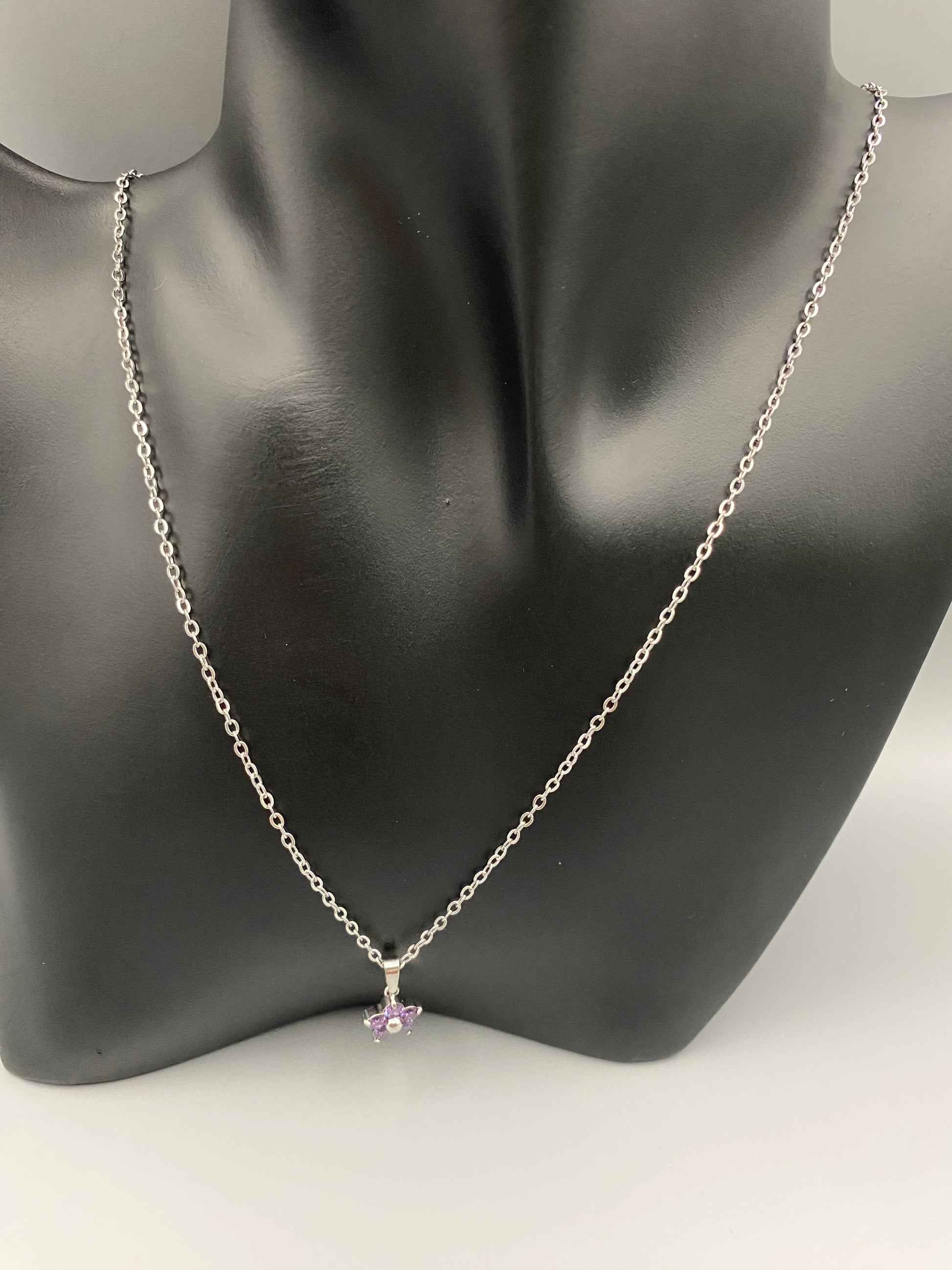 “Blossom Silver Pendant Necklace with a plum blossom design, featuring colourful cubic zirconia stones in a claw setting. Made from durable stainless steel with PVD plating. Measures 46 cm with a 5 cm adjustment.”