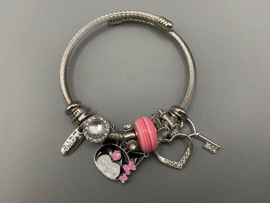 “Cartoon Character Bracelet in pink with a playful and stylish design, made from durable stainless steel, alloy charms, crystals, and glass beads. Adjustable 6cm diameter for a comfortable fit.”