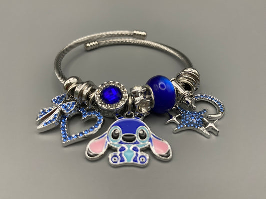 “Cartoon Character Bracelet in Blue with a playful and stylish design, made from durable stainless steel, alloy charms, crystals, and glass beads. Adjustable 6cm diameter for a comfortable fit.”