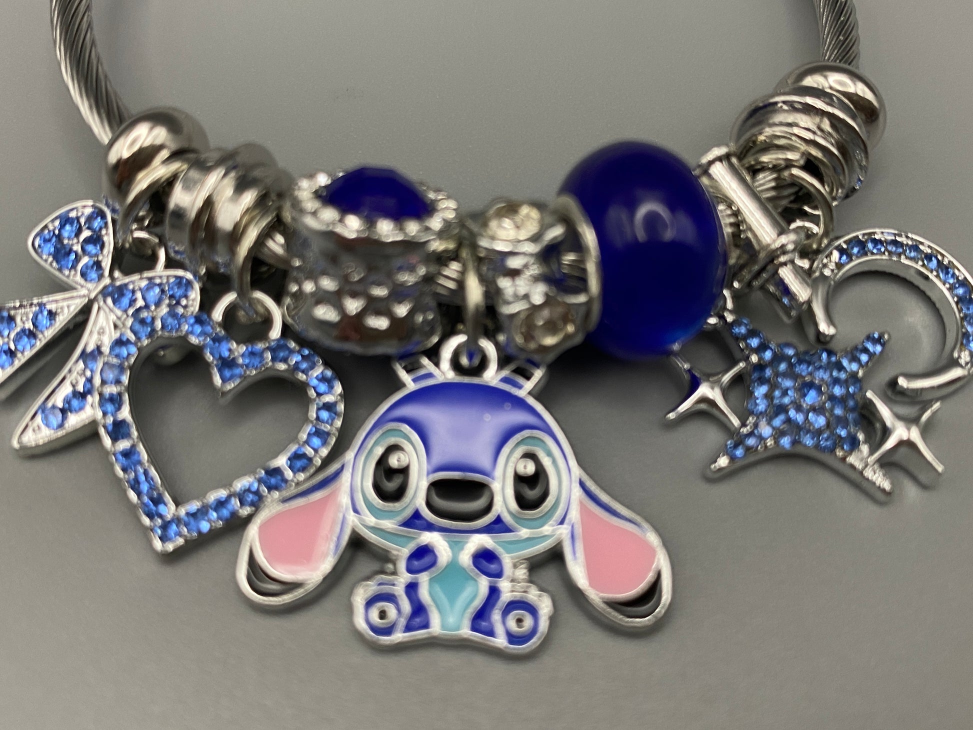 “Cartoon Character Bracelet in Blue with a playful and stylish design, made from durable stainless steel, alloy charms, crystals, and glass beads. Adjustable 6cm diameter for a comfortable fit.”
