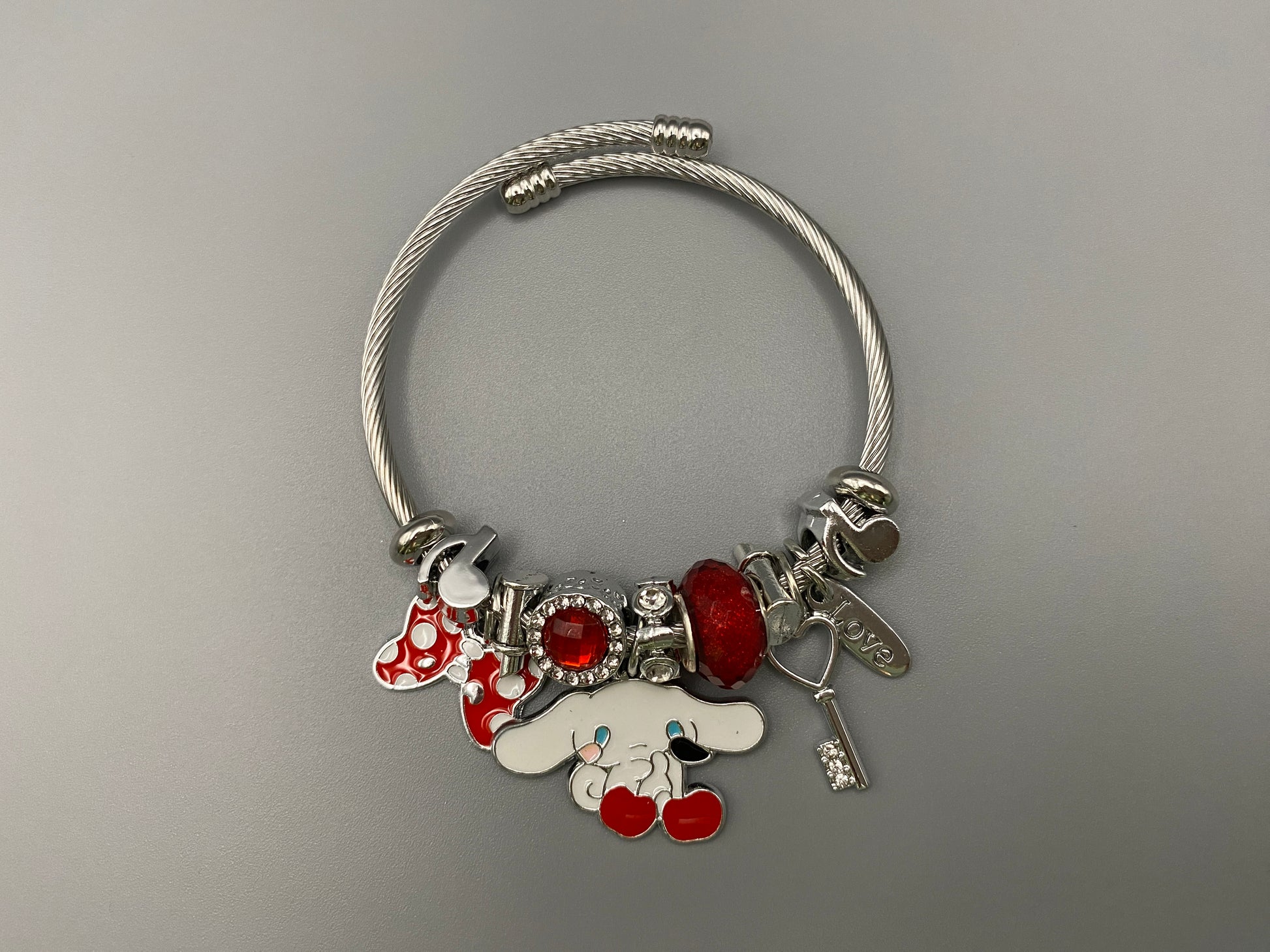 “Cartoon Character Bracelet in Red with a playful and stylish design, made from durable stainless steel, alloy charms, crystals, and glass beads. Adjustable 6cm diameter for a comfortable fit.”