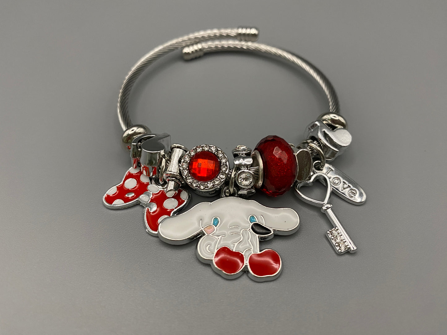 “Cartoon Character Bracelet in Red with a playful and stylish design, made from durable stainless steel, alloy charms, crystals, and glass beads. Adjustable 6cm diameter for a comfortable fit.”