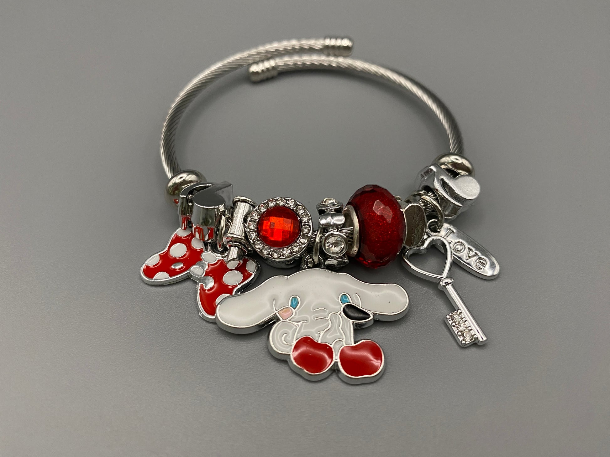 “Cartoon Character Bracelet in Red with a playful and stylish design, made from durable stainless steel, alloy charms, crystals, and glass beads. Adjustable 6cm diameter for a comfortable fit.”