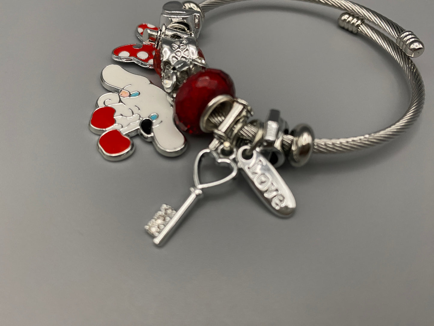 “Cartoon Character Bracelet in Red with a playful and stylish design, made from durable stainless steel, alloy charms, crystals, and glass beads. Adjustable 6cm diameter for a comfortable fit.”