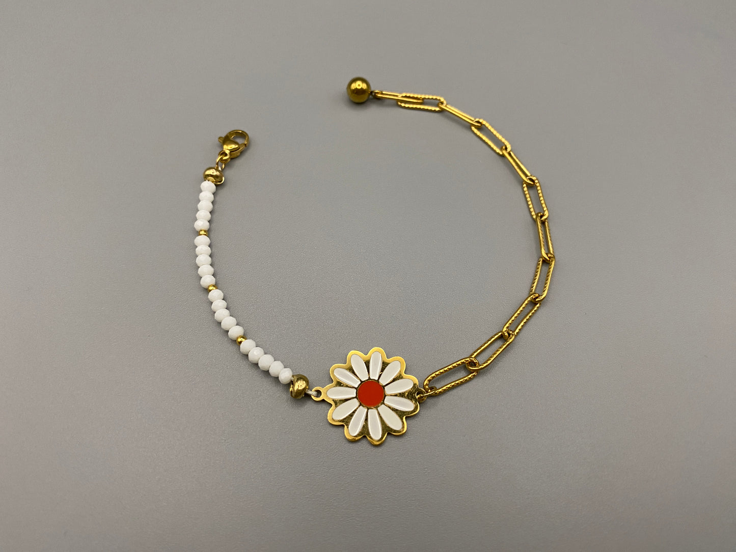 Daisy Chain Bead Bracelet in white, crafted from stainless steel with 18K gold plating. Features a daisy flower pattern with crystal and rhinestone accents. Eco-friendly, nickel and lead-free, safe for sensitive skin.”