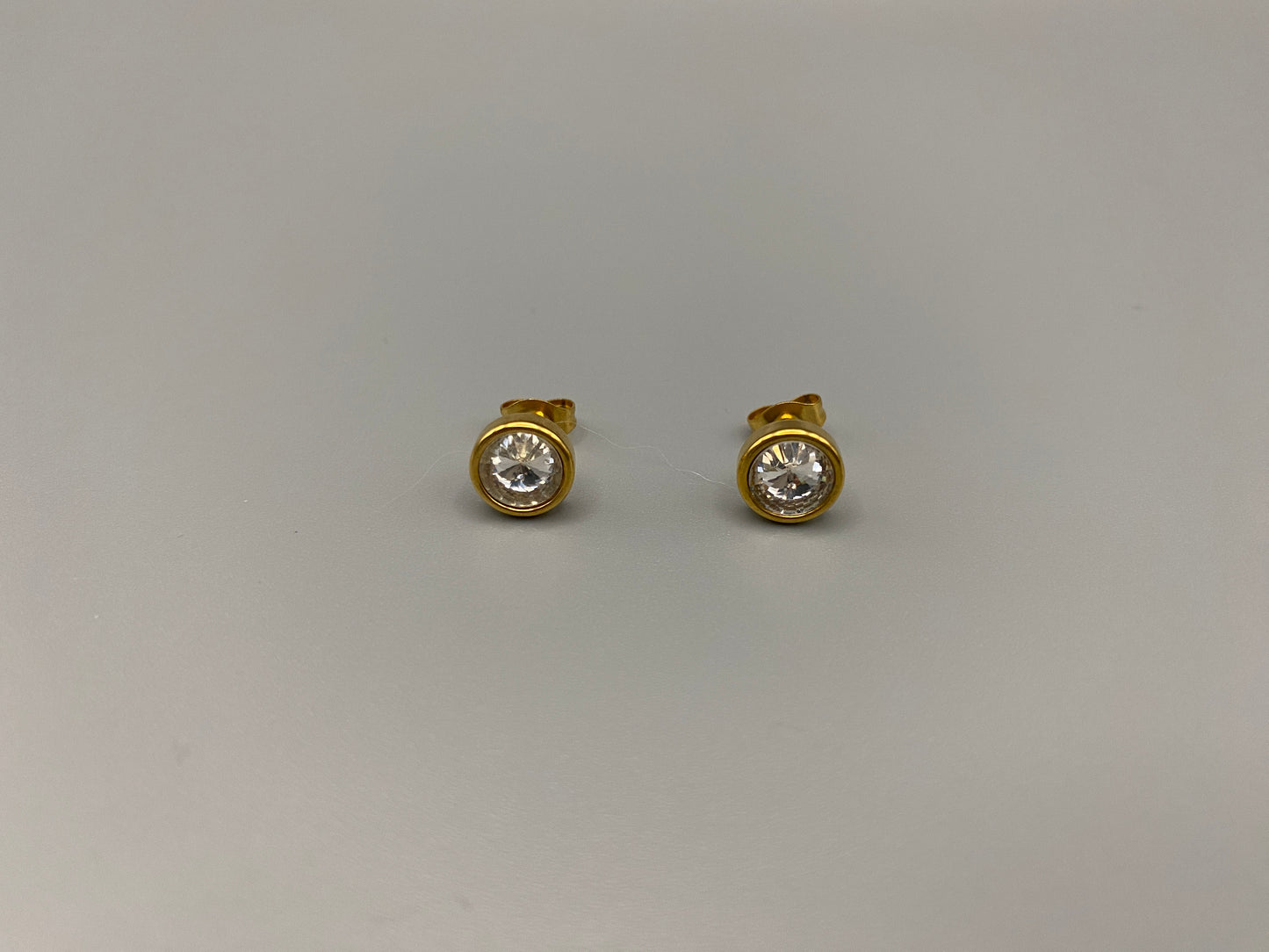 Chic stud earrings featuring dazzling AAA Zircon stones set in high-quality 304 stainless steel, gold plated, with an 8mm size and micro insert inlay technology. These earrings offer a perfect blend of elegance and durability.