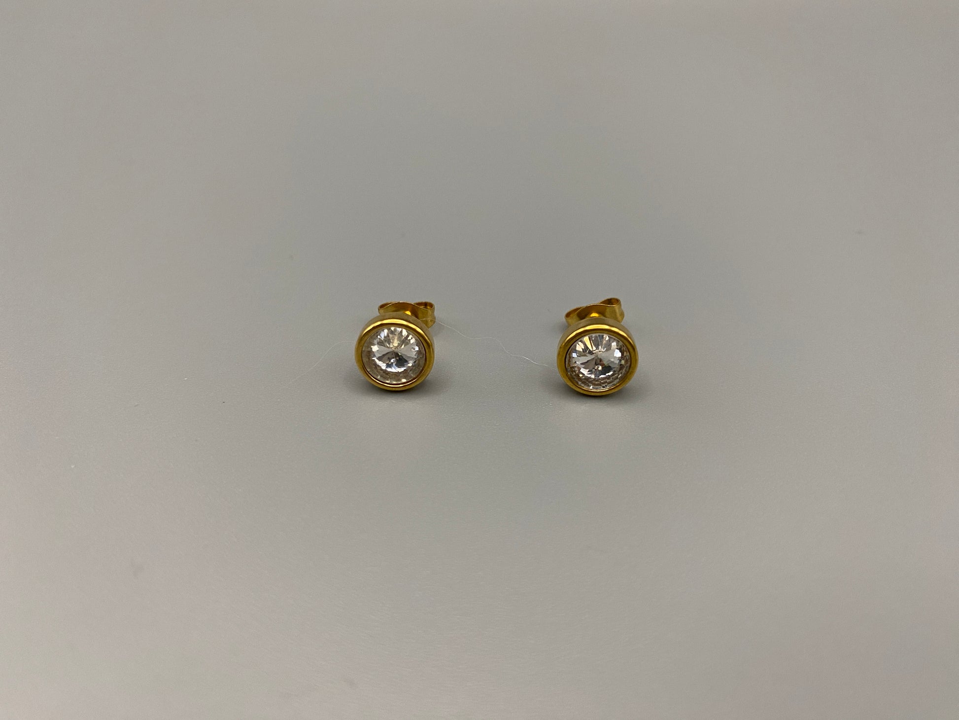 Chic stud earrings featuring dazzling AAA Zircon stones set in high-quality 304 stainless steel, gold plated, with an 8mm size and micro insert inlay technology. These earrings offer a perfect blend of elegance and durability.