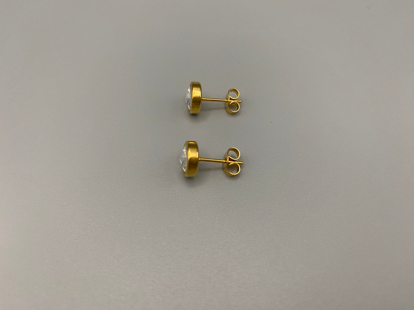 Chic stud earrings featuring dazzling AAA Zircon stones set in high-quality 304 stainless steel, gold plated, with an 8mm size and micro insert inlay technology. These earrings offer a perfect blend of elegance and durability.