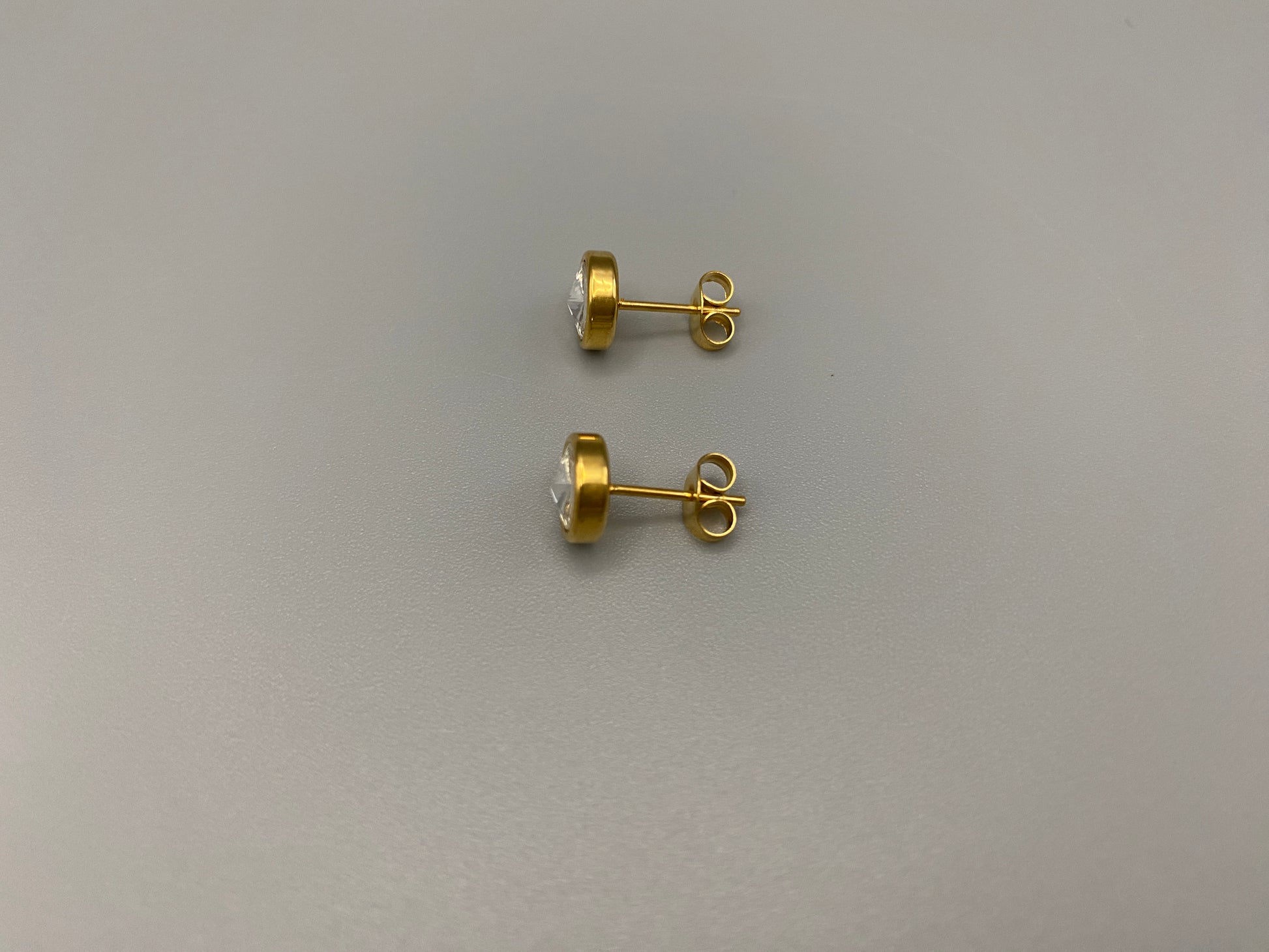 Chic stud earrings featuring dazzling AAA Zircon stones set in high-quality 304 stainless steel, gold plated, with an 8mm size and micro insert inlay technology. These earrings offer a perfect blend of elegance and durability.