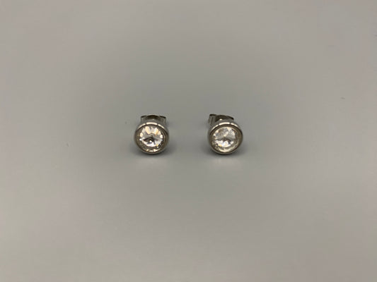 Elara Stud Earrings Silver Chic stud earrings featuring dazzling AAA Zircon stones set in high-quality 304 stainless steel, silver plated, with an 8mm size and micro insert inlay technology. These earrings offer a perfect blend of elegance and durability.