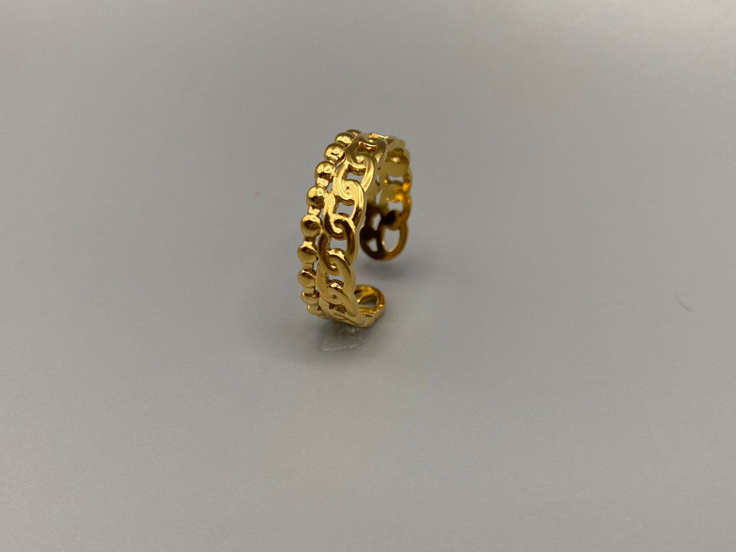 This unique ring features a dual chain design, creating an open and airy look that is both modern and elegant. The open hollow dual chain design adds a contemporary touch, while the gold plating ensures a luxurious finish. Made from durable titanium and stainless steel, it offers strength and longevity. Available in size 6, it provides a comfortable fit. Perfect for any occasion, this versatile accessory complements both casual and formal outfits.