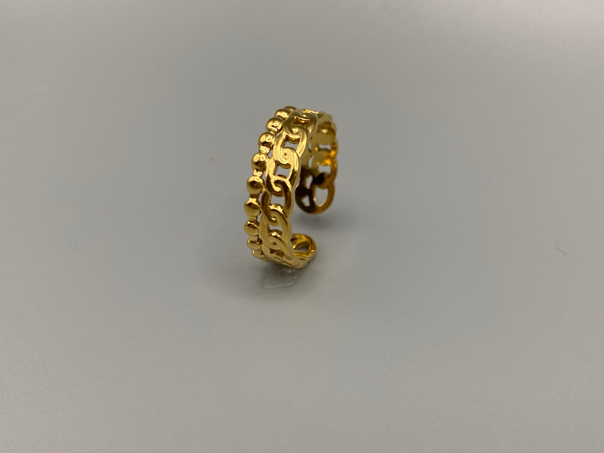 This unique ring features a dual chain design, creating an open and airy look that is both modern and elegant. The open hollow dual chain design adds a contemporary touch, while the gold plating ensures a luxurious finish. Made from durable titanium and stainless steel, it offers strength and longevity. Available in size 6, it provides a comfortable fit. Perfect for any occasion, this versatile accessory complements both casual and formal outfits.