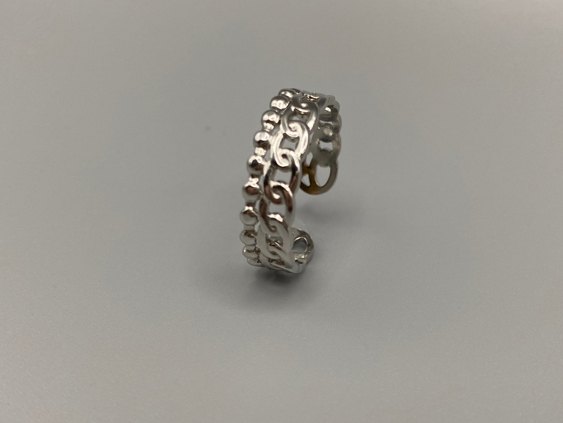 This unique ring features a dual chain design, creating an open and airy look that is both modern and elegant. The open hollow dual chain design adds a contemporary touch, while the plating ensures a luxurious finish. Made from durable titanium and stainless steel, it offers strength and longevity. Available in size 6, it provides a comfortable fit. Perfect for any occasion, this versatile accessory complements both casual and formal outfits.