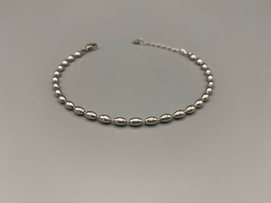 “Elliptica Bracelet in silver with connected oval-shaped links, featuring a modern and sophisticated design. Made from durable stainless steel with a silver finish. Measures 17 cm with a 3 cm extender for adjustable fit.”