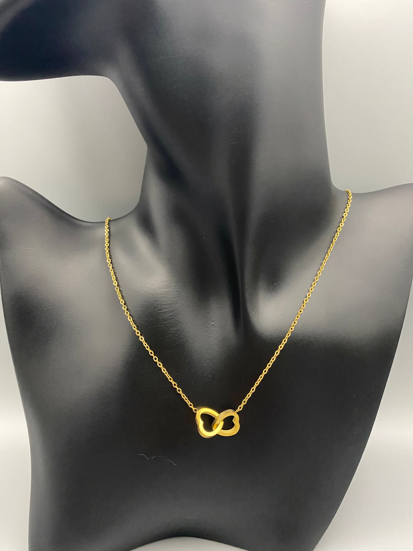 Eternity Twin Hearts Pendant Necklace Gold. Two intertwined hearts symbolizing eternal love. 18k gold, non-tarnish, waterproof, non-fade. Adjustable length: 41 cm + 5 cm extender. Elegant and versatile for any occasion.