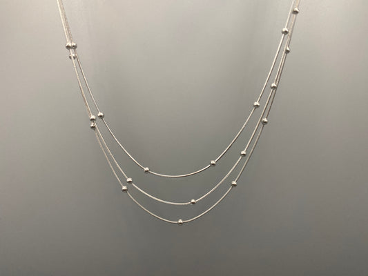 Elegant tri-chain design with bead accents. silver plated, PVD plated for durability. Adjustable length: 40 cm + 5 cm extender. Versatile for layering or solo wear.