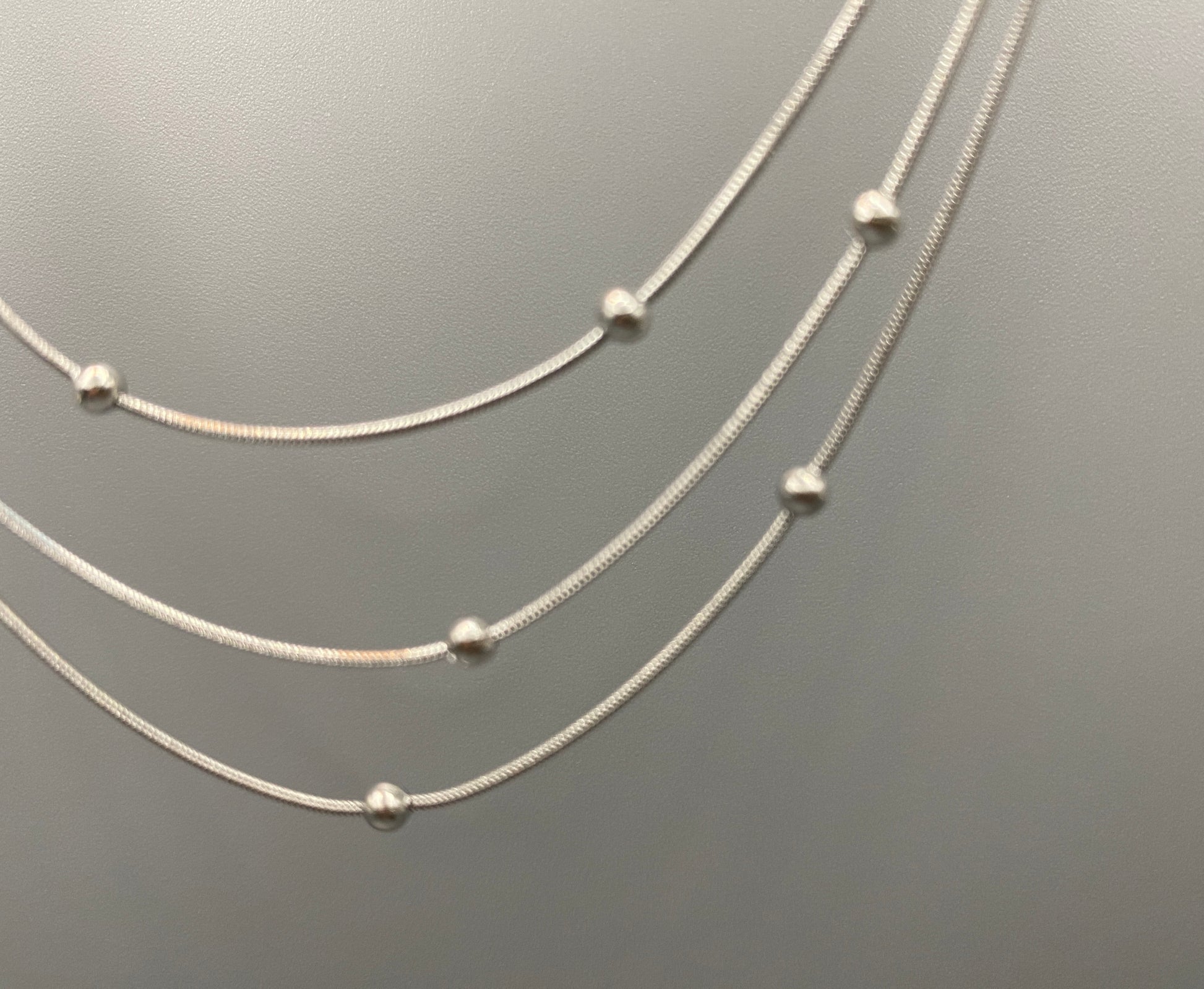 Elegant tri-chain design with bead accents. silver plated, PVD plated for durability. Adjustable length: 40 cm + 5 cm extender. Versatile for layering or solo wear.