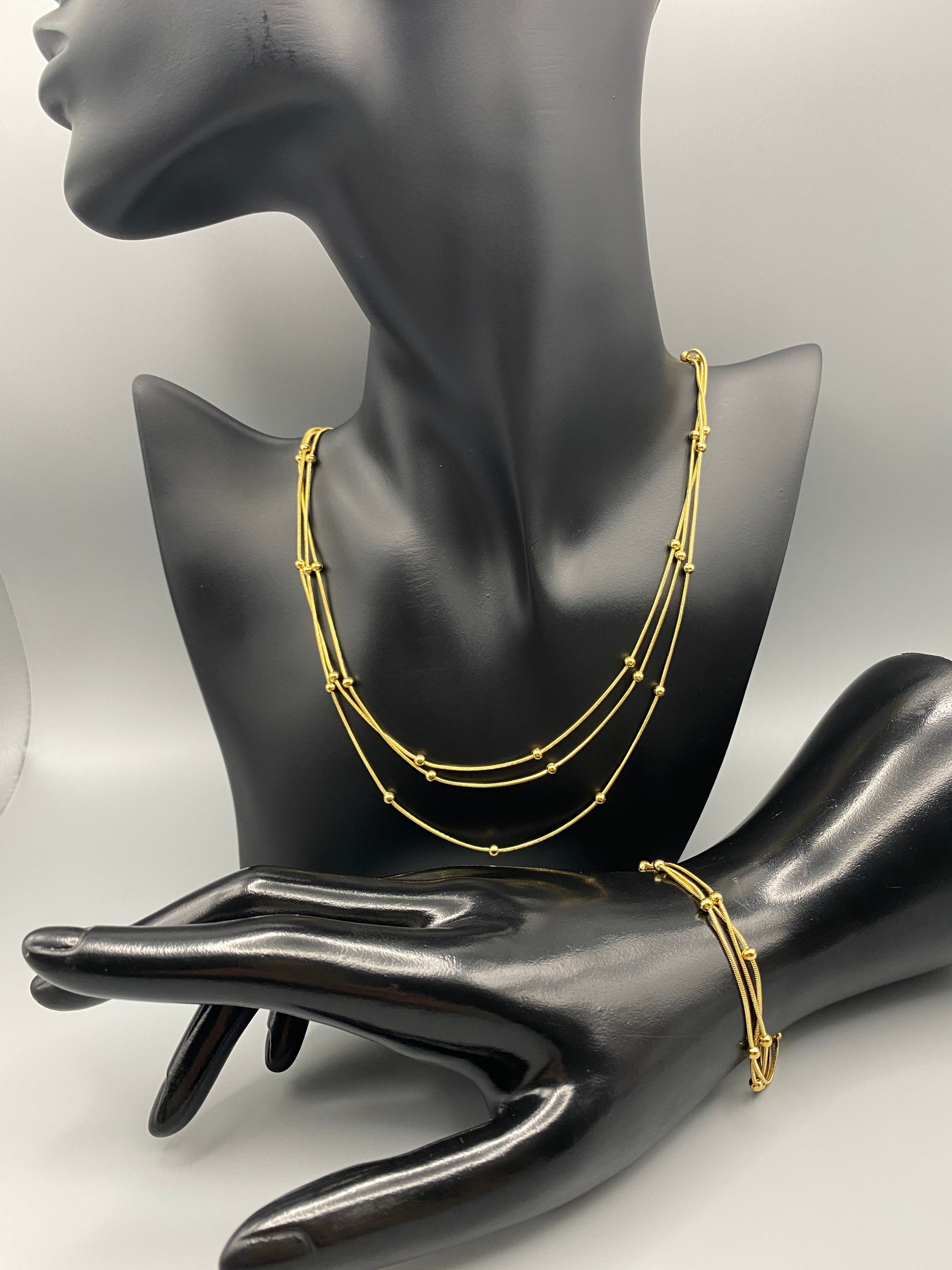 Freya Tri-Chained Bead Bracelet in gold with three delicate chains and evenly spaced small beads. 18K gold plated, made from durable stainless steel with PVD plating. Measures 18 cm with a 3 cm extender for adjustable fit.”