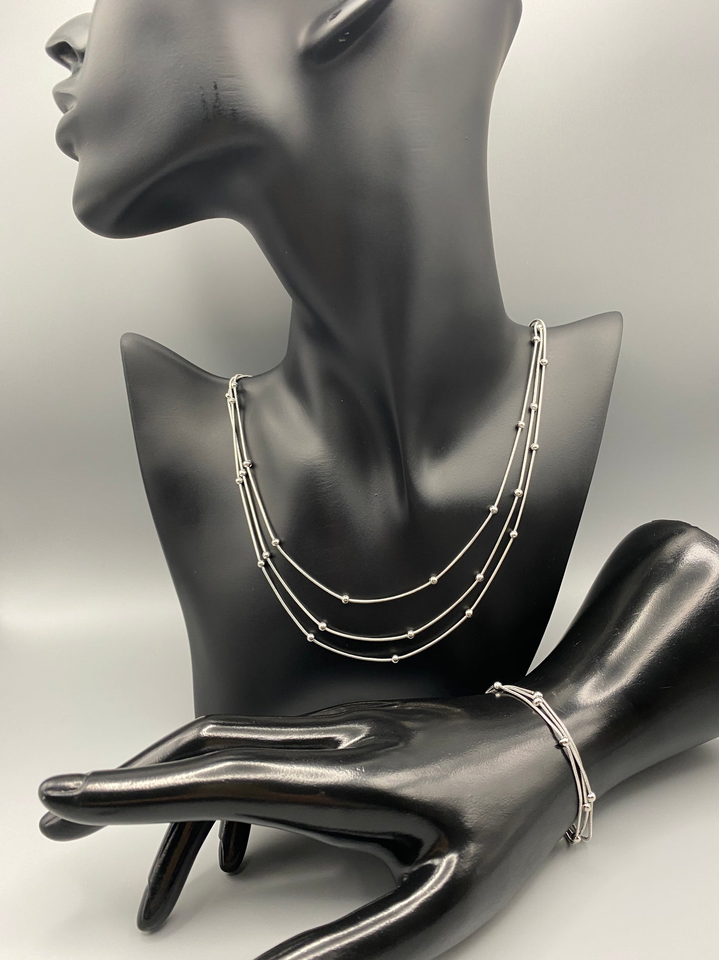 “Freya Tri-Chained Bead Bracelet in silver with three delicate chains and evenly spaced small beads. Silver plated, made from durable stainless steel with PVD plating. Measures 18 cm with a 3 cm extender for adjustable fit.”