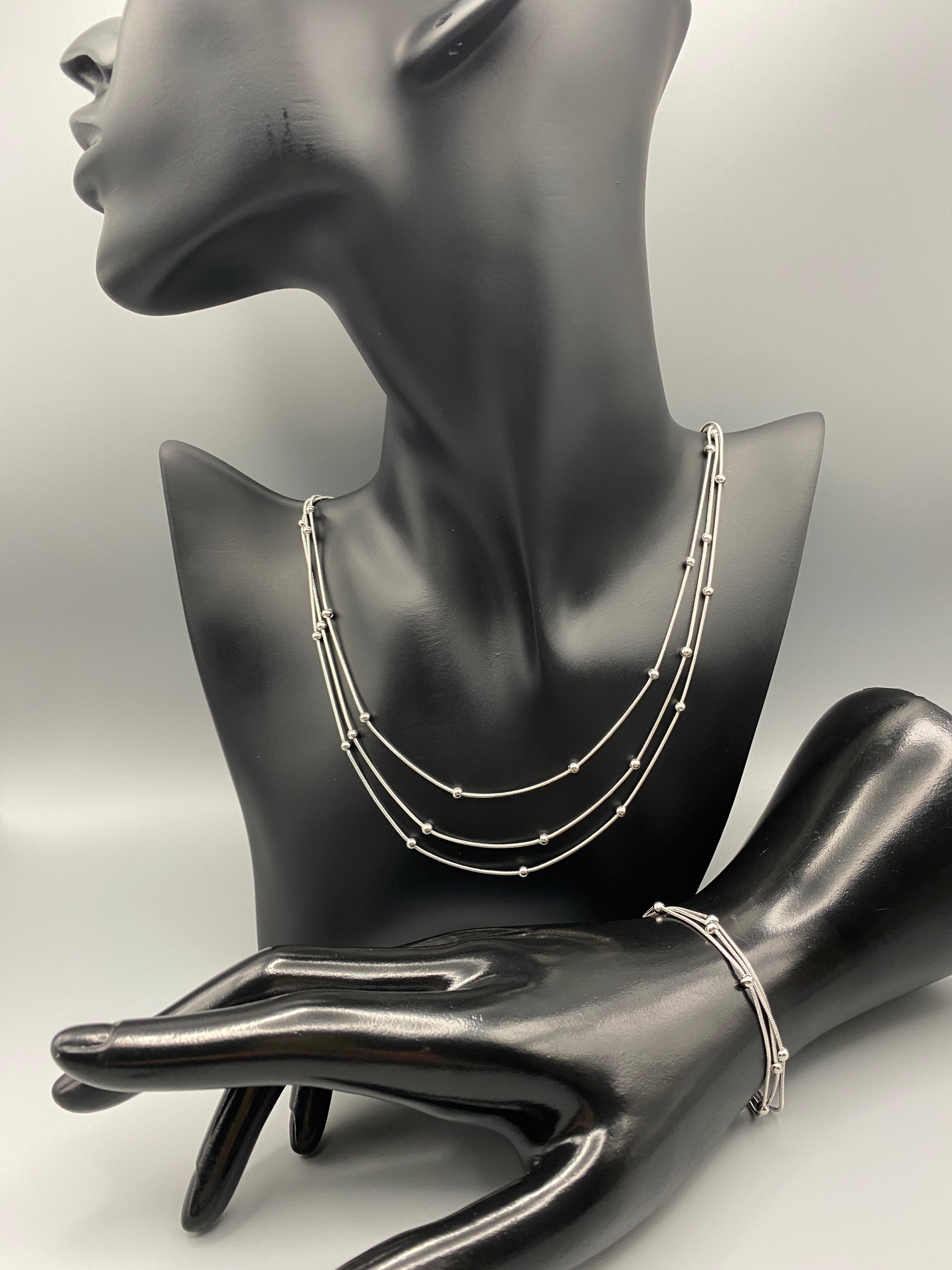 “Freya Tri-Chained Bead Bracelet in silver with three delicate chains and evenly spaced small beads. Silver plated, made from durable stainless steel with PVD plating. Measures 18 cm with a 3 cm extender for adjustable fit.”