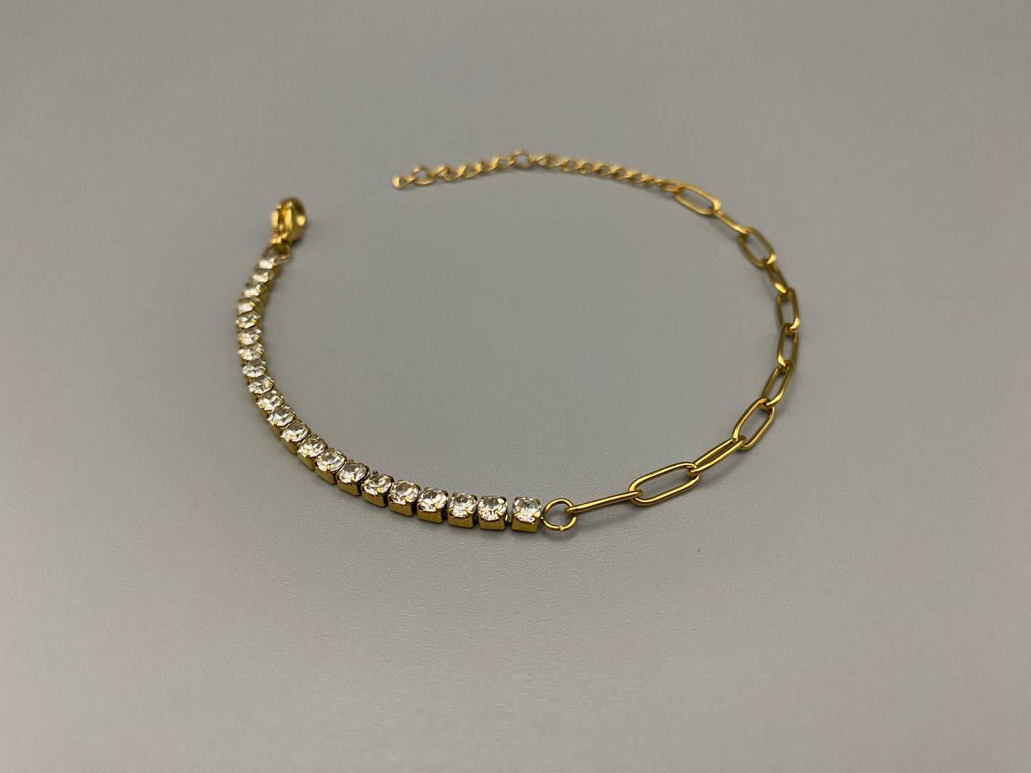 “Gemma Bracelet in gold with iced-out zircon paperclip chain, crafted from tarnish-free stainless steel and plated with 18K gold. Waterproof and perfect for daily wear or special occasions.”