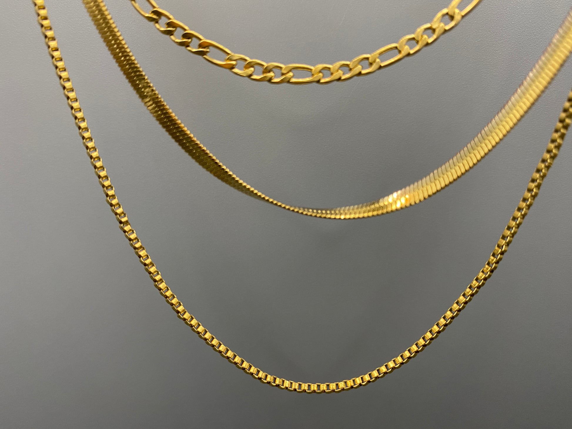 Gina Three Layered Gold Chain Necklace. Three delicate chains layered for a sophisticated look. 18k gold plated, PVD plated for durability. Stainless steel, corrosion-resistant. Adjustable length: 40 cm + 5 cm extender. Versatile for casual and formal wear.