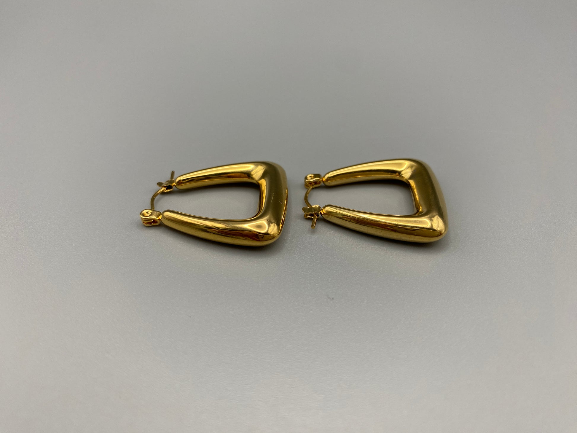 Harmony Gold Earrings made from stainless steel with PVD 18k gold and titanium plating. Hypoallergenic, lead and nickel-free, perfect for sensitive skin. Featuring a trendy geometric shape and tarnish-free colour retention, these earrings blend elegance and durability.