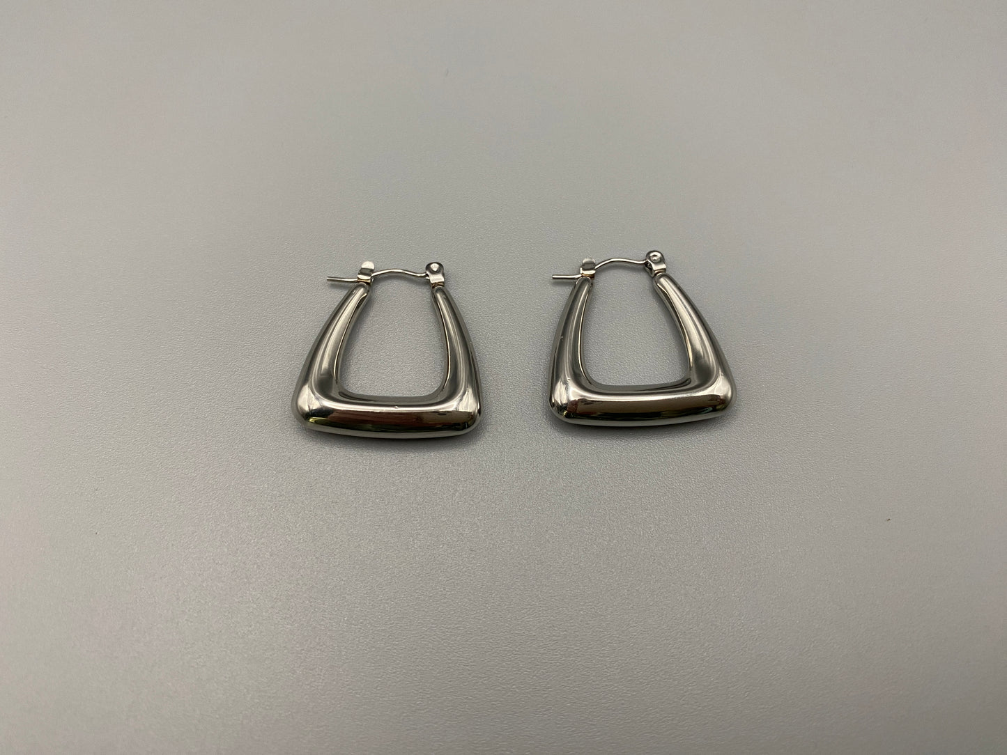 Harmony Silver Earrings made from stainless steel with PVD silver and titanium plating. Hypoallergenic, lead and nickel-free, perfect for sensitive skin. Featuring a trendy geometric shape and tarnish-free colour retention, these earrings blend elegance and durability.