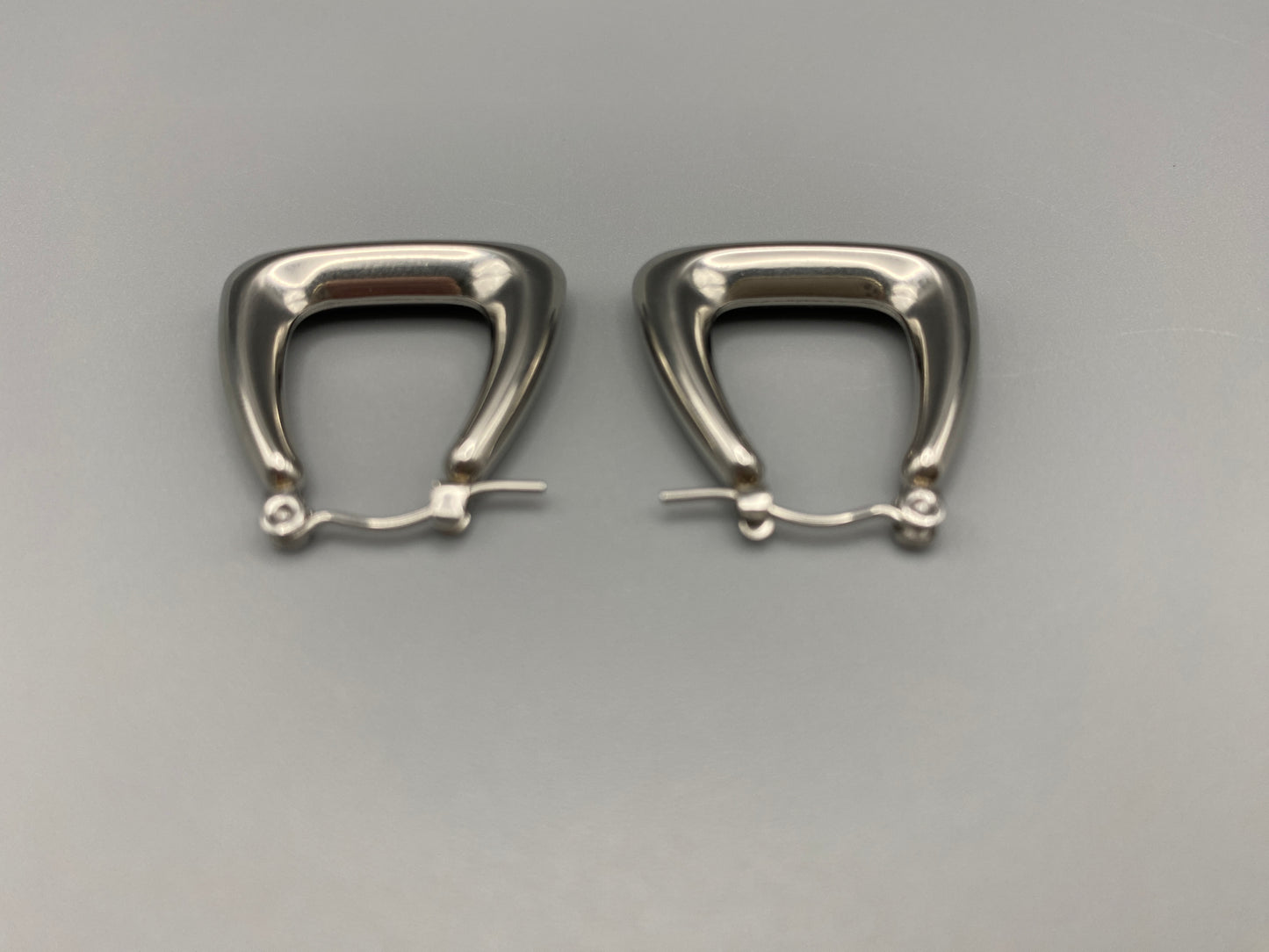 Harmony Silver Earrings made from stainless steel with PVD silver and titanium plating. Hypoallergenic, lead and nickel-free, perfect for sensitive skin. Featuring a trendy geometric shape and tarnish-free colour retention, these earrings blend elegance and durability.