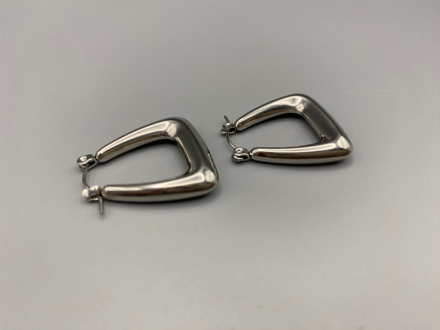 Harmony Silver Earrings made from stainless steel with PVD silver and titanium plating. Hypoallergenic, lead and nickel-free, perfect for sensitive skin. Featuring a trendy geometric shape and tarnish-free colour retention, these earrings blend elegance and durability.