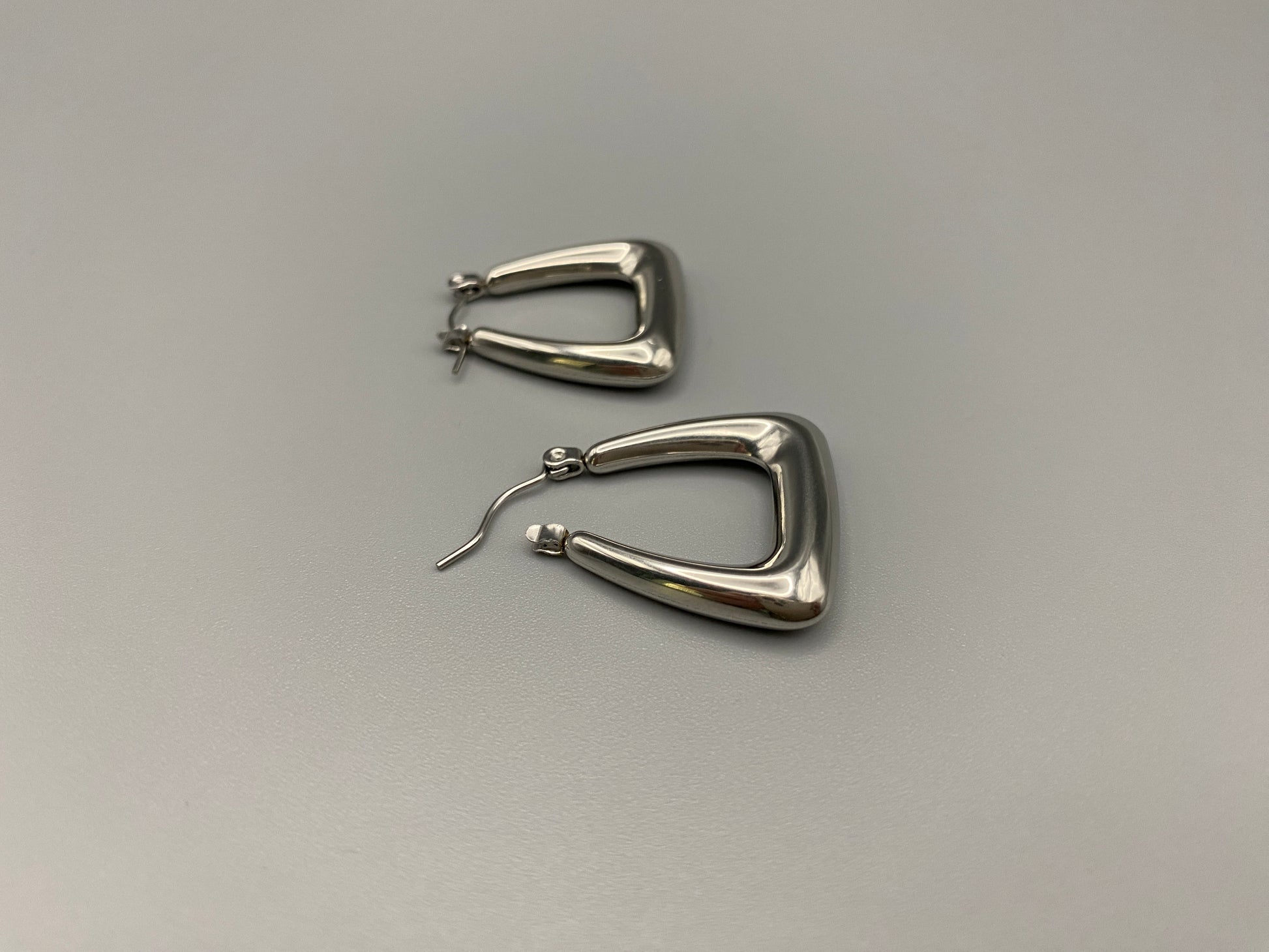 Harmony Silver Earrings made from stainless steel with PVD silver and titanium plating. Hypoallergenic, lead and nickel-free, perfect for sensitive skin. Featuring a trendy geometric shape and tarnish-free colour retention, these earrings blend elegance and durability.