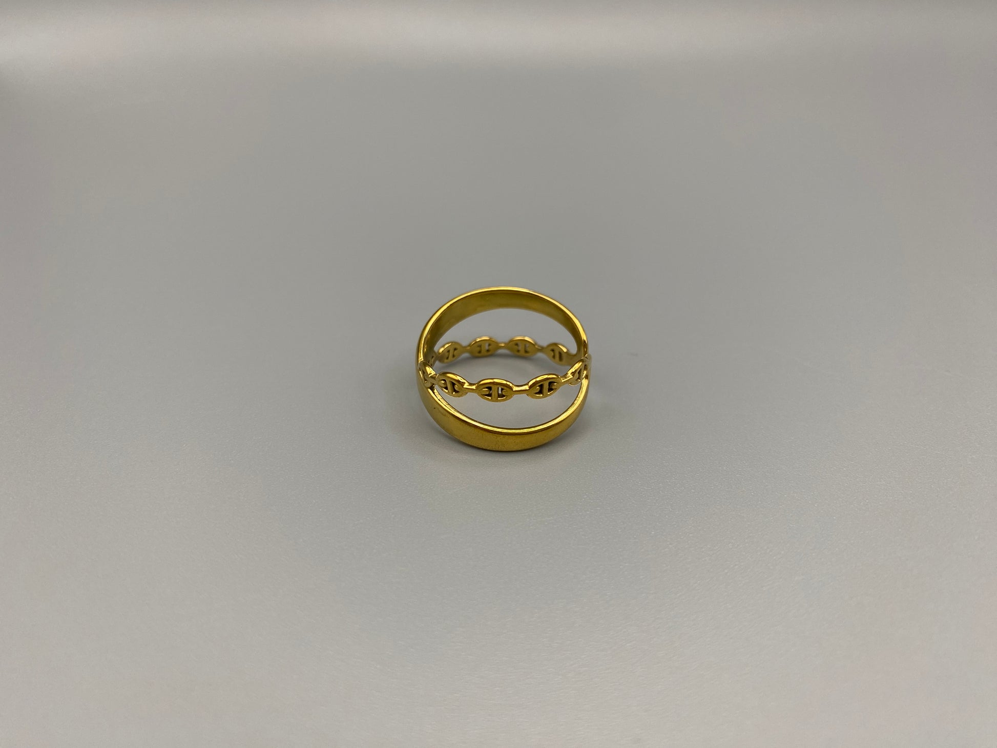 Francesca Ring Gold: A stunning piece of jewellery that combines elegance with modern design. Crafted from high-quality stainless steel and plated with gold, it features a double-layer ‘D’ shape and an adjustable band. This ring is nickel-free and lead-free, ensuring safety for sensitive skin. The channel setting adds a touch of sophistication. Perfect for gifts, anniversaries, parties, and more, the adjustable band ensures a perfect fit for any finger size, making it a versatile addition to any jewellery 